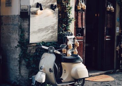 Trastevere vespa cobblestone street