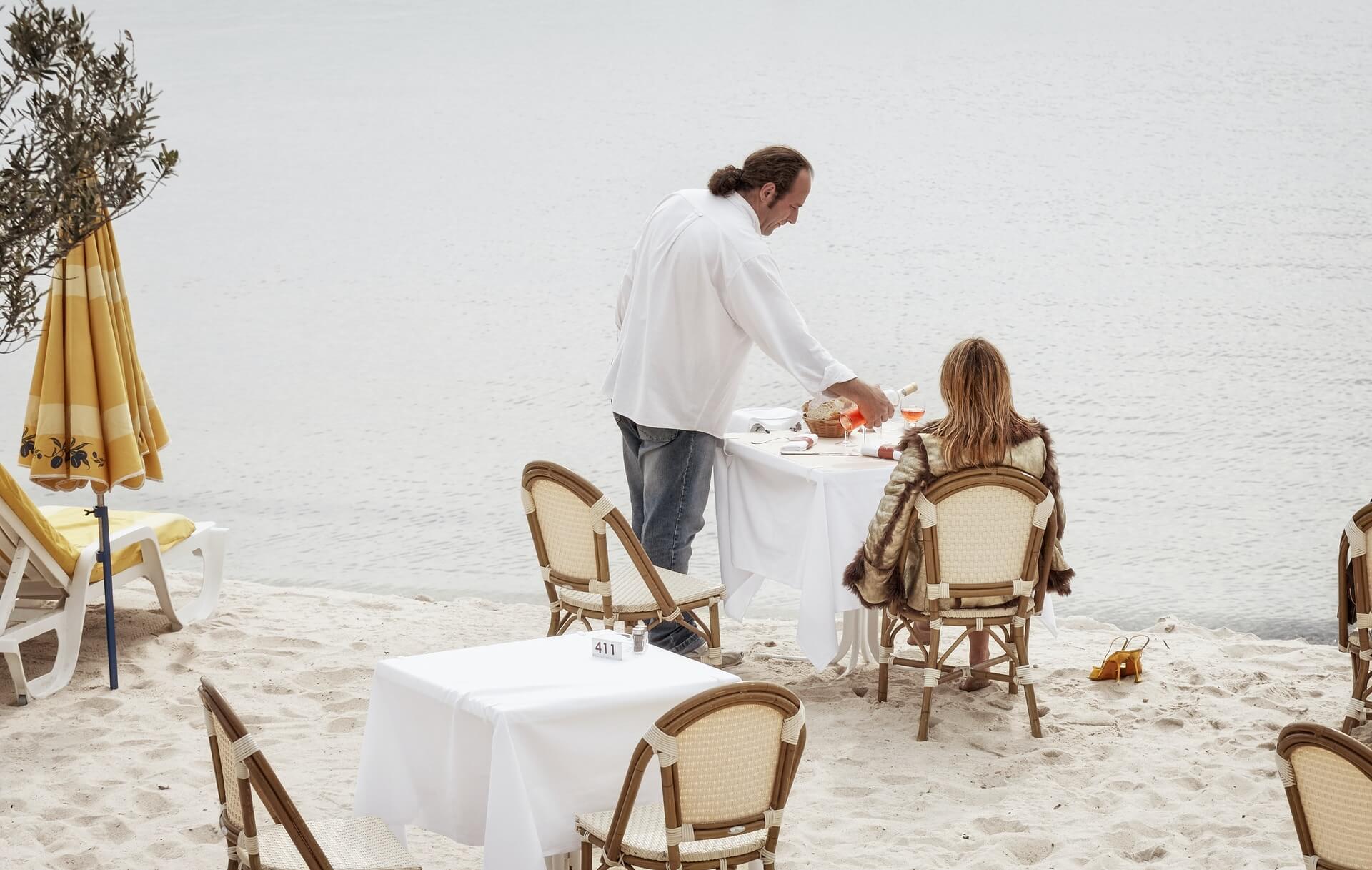 Tee McNeill McNeill Luxury Travel Photo by Vidar Nordli-Mathisen man and woman having meal at the shore
