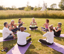 a group of people doing yoga in a park